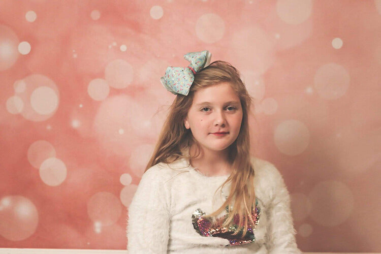 A girl in front of bokeh backdrop