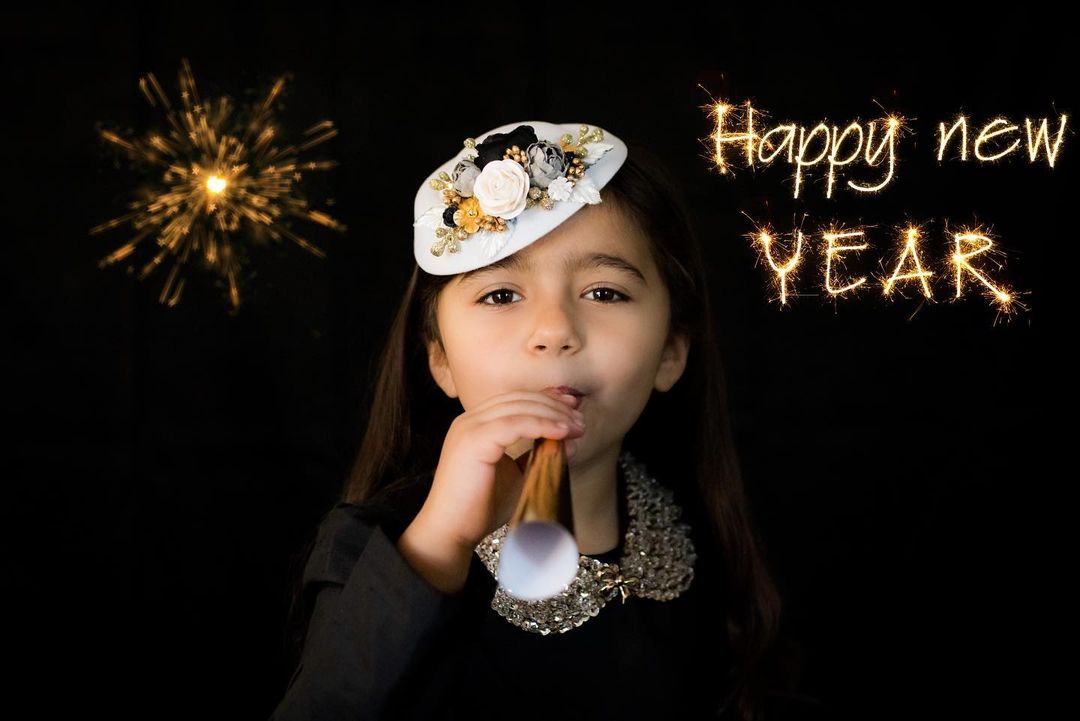 A girl in front of a solid black backdrop