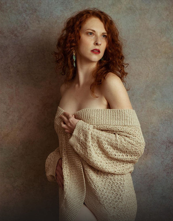 A beautiful woman standing in front of a abstract rusty texture backdrop
