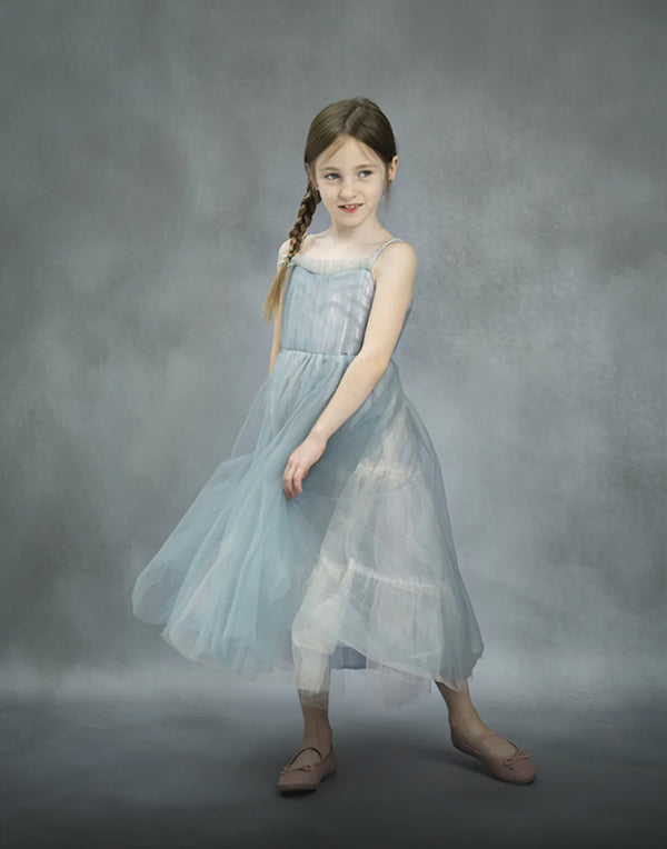 Girl standing in front of a gray texture vinyl backdrop