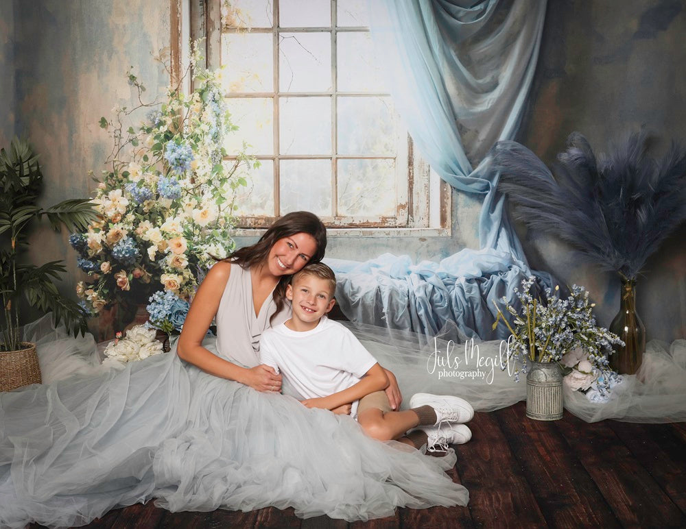 Mother and son sitting on the floor in front of spring window backdrop